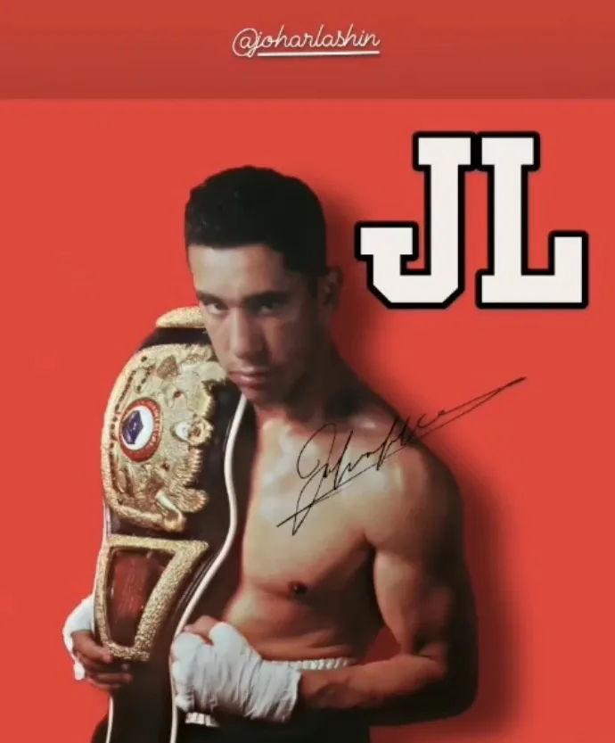 Johar Lashin, 3× World Champion, holding his championship belt with signature JL branding