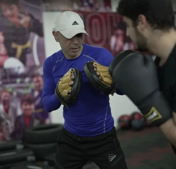 Coach Johar Lashin working mitts with a fighter